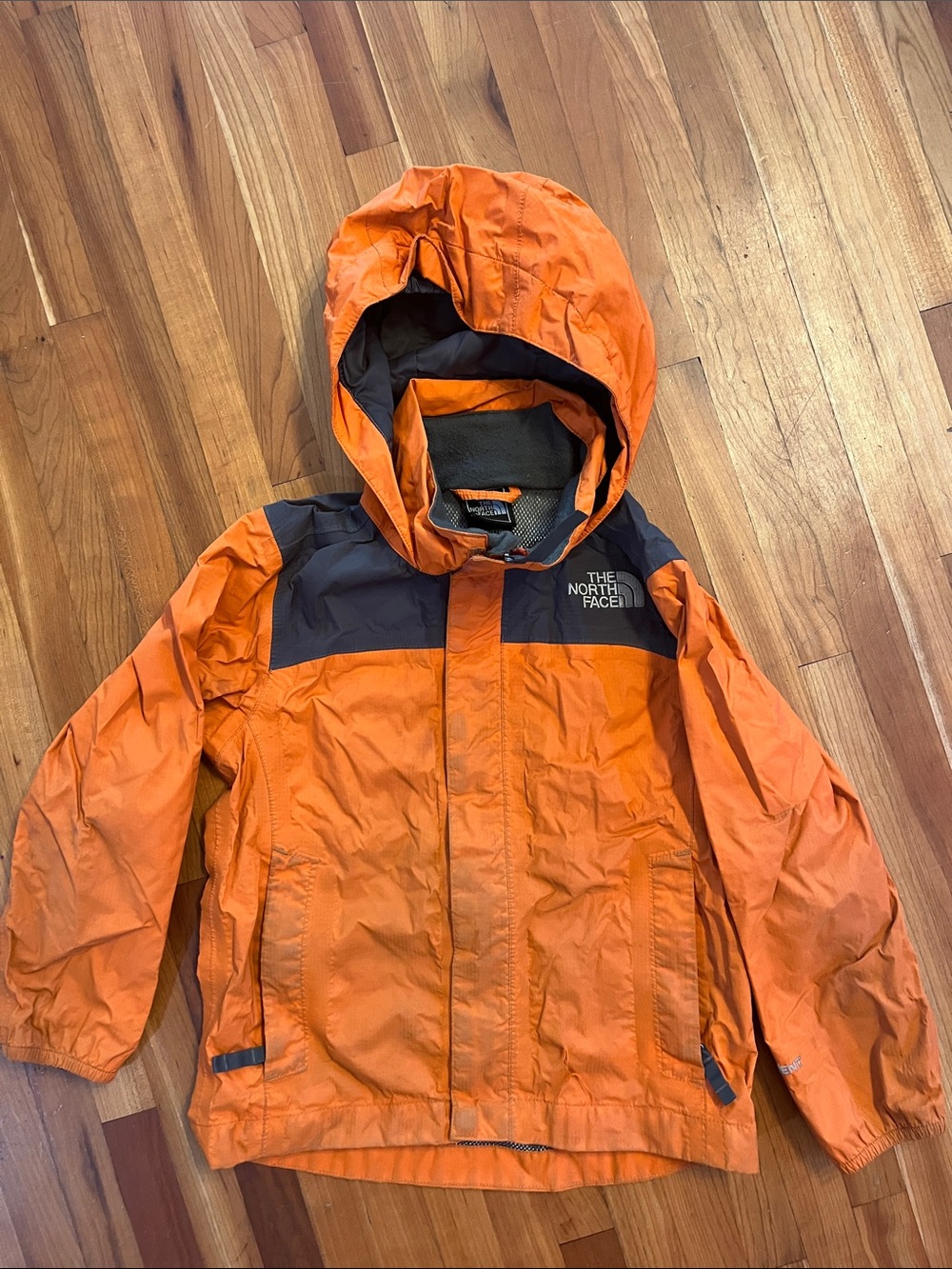 The North Face Orange Hooded Kids Rain Jacket with Black Yoke